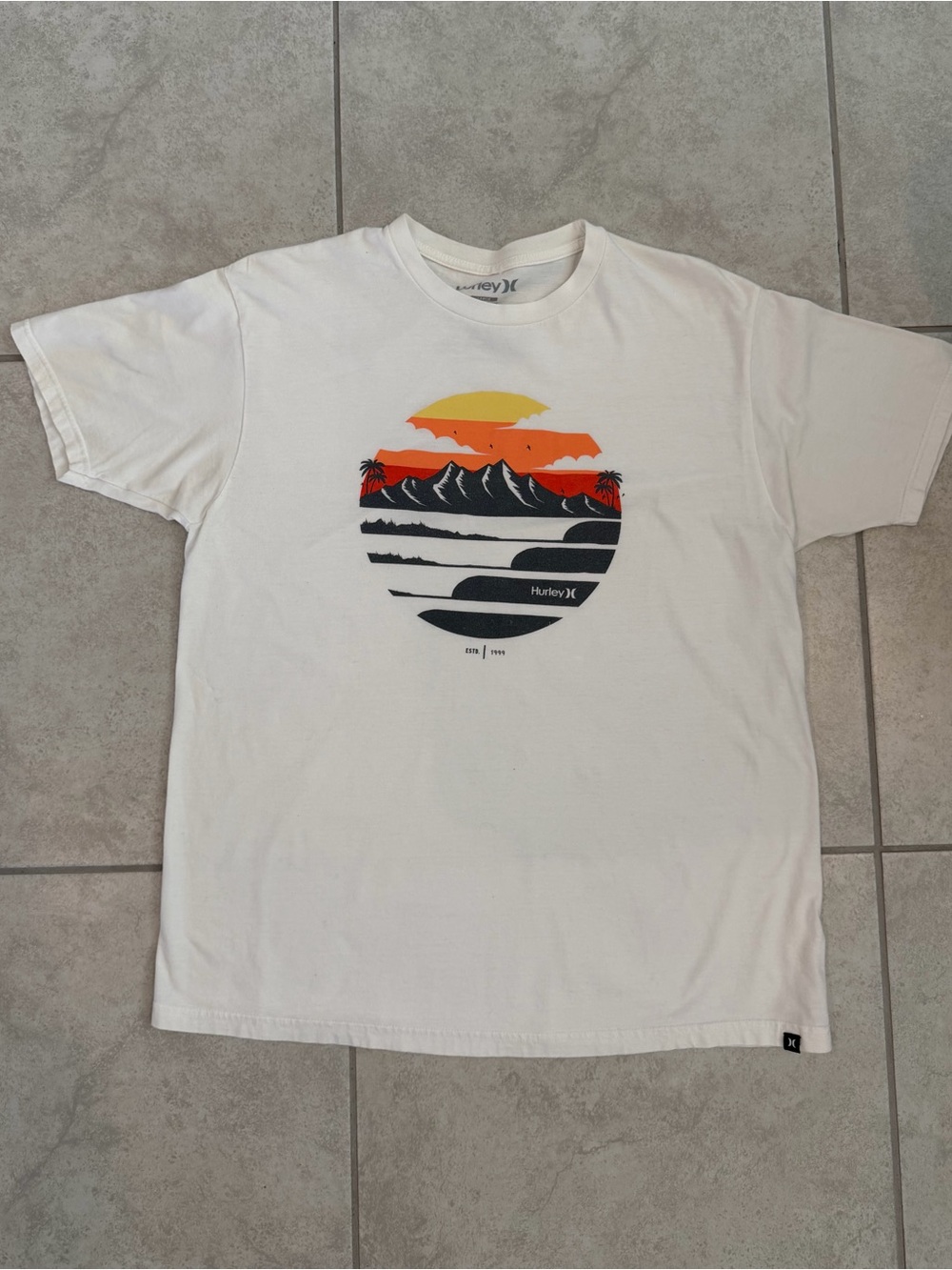 Hurley White T-Shirt with Sunset Graphic in Yellow, Orange and charcoal gray.